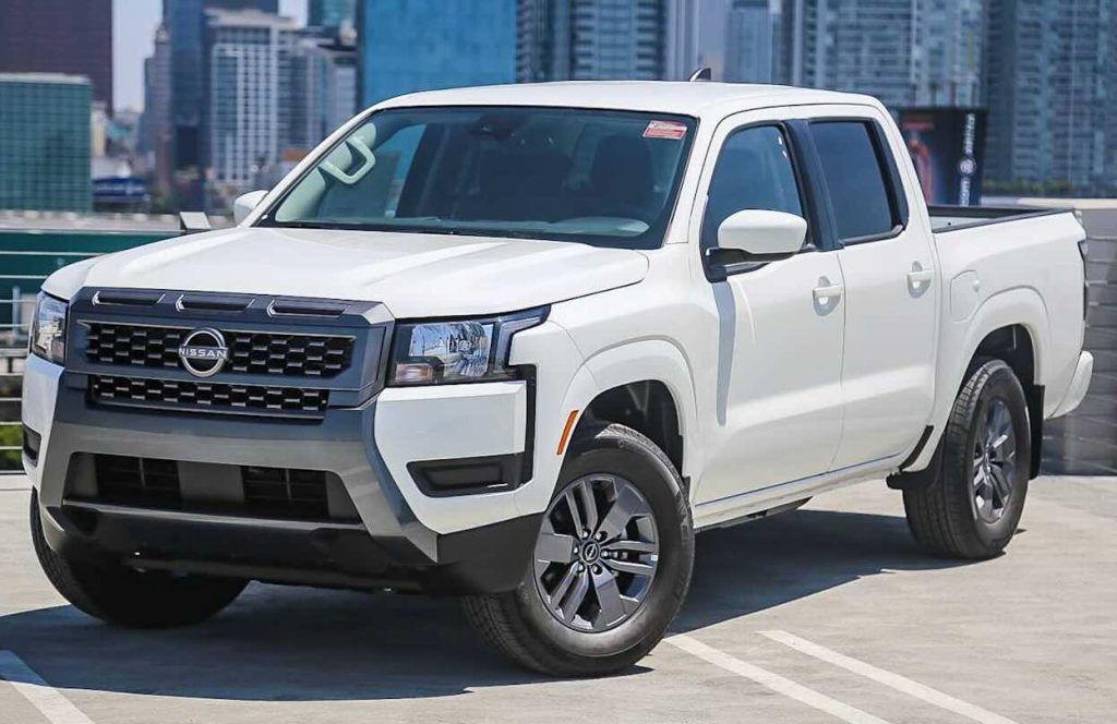 A photo of a white Nissan Frontier SV with a crew cab.