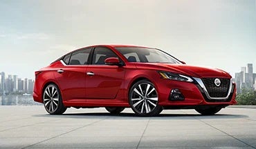 2023 Nissan Altima in red with city in background illustrating last year's 2022 model in Nationwide Nissan in Timonium MD