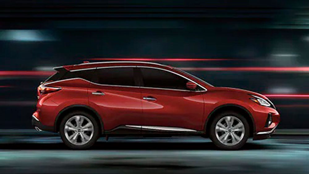 2023 Nissan Murano shown in profile driving down a street at night illustrating performance. | Nationwide Nissan in Timonium MD